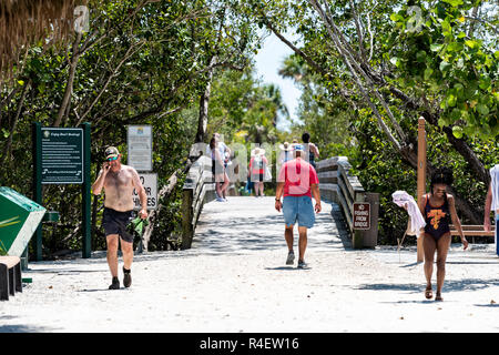 Sanibel Island, USA - April 29, 2018: Bowman's beach with sandy trail, path, walkway, bridge, many people, tourists walking Stock Photo