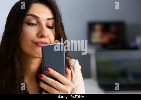 Young beautiful businesswoman unhappily holding Stock Photo