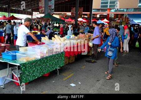 Tables stalls selling fresh street food & fruit at outdoor section of Satok Weekend Market Kuching Malaysia Stock Photo