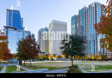 CHARLOTTE, NC, USA-11/21/18: Romare Bearden Park, with skyscrapers in the background. Stock Photo