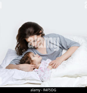 Beautiful mother and daughter in bed Stock Photo