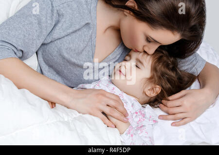 Beautiful mother and daughter in bed Stock Photo