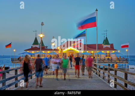 Pier Ahlbeck on the Baltic Sea with national flags in the wind. - Letters with Historische Seebrücke Ahlbeck means Ahlbeck Historic Pier. Stock Photo