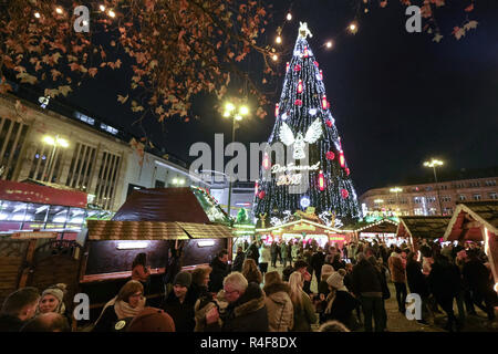 The biggest Christmas tree is on the Christmas market in Dortmund, Germany. 45 meters high, built of 1700 spruce trees, 40.000 LED lights, large red candles and decorated with angels. Stock Photo