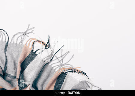 Flat lay blue casual checkered scarf with fringe in corner on white background, top view. Stock Photo