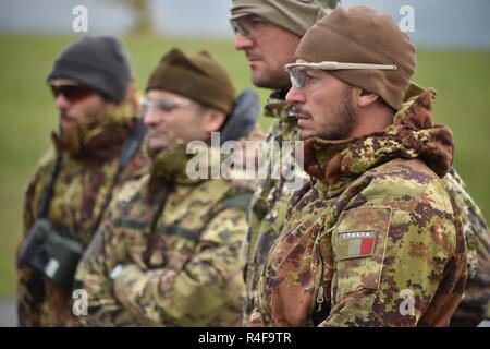 Italian soldiers listen to a safety briefing before they conduct the High Angle Shot lane during the European Best Sniper Squad Competition at the 7th Army Training Command’s, Grafenwoehr Training Area, Bavaria, Germany, Oct. 24, 2016. The European Best Sniper Squad Competition is an Army Europe competition challenging militaries from across Europe to compete and enhance teamwork with Allies and partner nations. Stock Photo