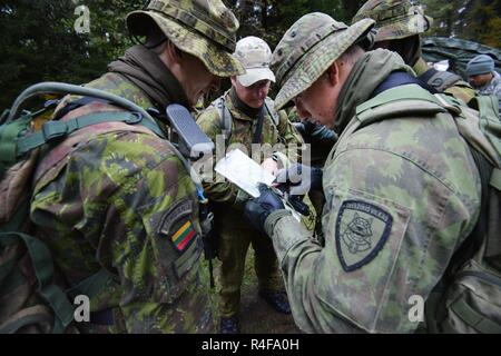 Lithuanian soldiers prepare for the Land Navigation lane during the European Best Sniper Squad Competition at the 7th Army Training Command’s, Grafenwoehr Training Area, Bavaria, Germany, Oct. 25, 2016. The European Best Sniper Squad Competition is an Army Europe competition challenging militaries from across Europe to compete and enhance teamwork with Allies and partner nations. Stock Photo