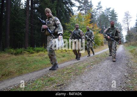 Lithuanian soldiers start the Land Navigation lane during the European Best Sniper Squad Competition at the 7th Army Training Command’s, Grafenwoehr Training Area, Bavaria, Germany, Oct. 25, 2016. The European Best Sniper Squad Competition is an Army Europe competition challenging militaries from across Europe to compete and enhance teamwork with Allies and partner nations. Stock Photo