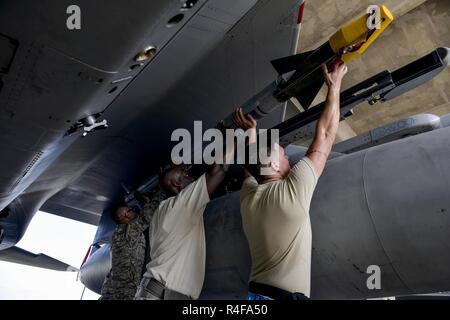 A weapons load crew team from the 44th Aircraft Maintenance Unit work ...