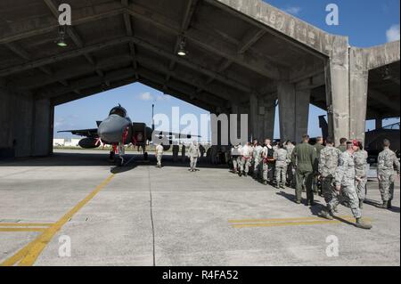 A weapons load team from the 44th Aircraft Maintenance Unit loads an ...
