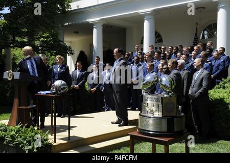 President Donald Trump congratulates the U.S. Air Force Academy football team with the Commander-in-Chief's Trophy at the White House May 2, 2017. With the team were Lt. Gen. Michelle D. Johnson, the superintendent of the U.S. Air Force Academy, Acting Secretary of the Air Force Lisa S. Disbrow and Air Force Chief of Staff Gen. David L. Goldfein. Stock Photo