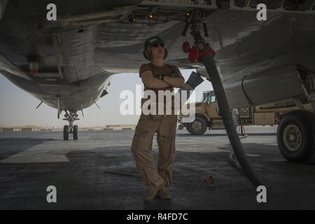 U.S. Naval Aircrewman (Mechinical) 3rd Class Melissa Ellis, assigned to Patrol Squadron FORTY-SIX (VP-46), performs routine maintenance on a P-3C Orion before a flight in support of Operation Inherent Resolve May 2, 2017. The P-3C has advanced submarine detection sensors such as directional frequency and ranging sonobuoys and magnetic anomaly detection equipment. The avionics system is integrated by a general purpose digital computer that supports all of the tactical displays, monitors and automatically launches ordnance and provides flight information to the pilots. Stock Photo