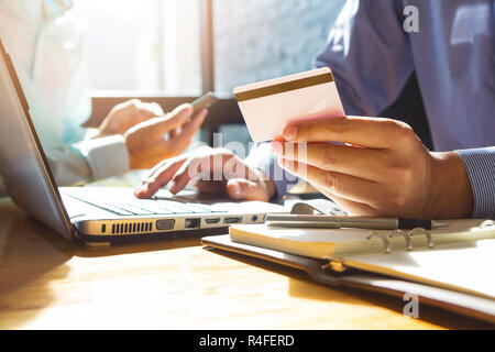 Businessman holding credit card and using laptop to shopping online Stock Photo