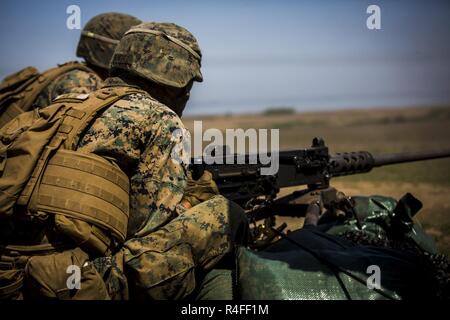U.S. Marine Lance Cpl. Cristian Benitez, a machine gunner with Marine Rotational Force Europe 17.1, fires a .50 caliber machine gun during Exercise Platinum Eagle 17.2, May 2, 2017.  Platinum Eagle allowed Marines to work with NATO Allies and partner nations, and maintain and improve on proficiency with various Marine Corps weapon systems. NATO Allies and partner nations stand together to ensure a Europe that is whole, free, at peace and prosperous. Stock Photo