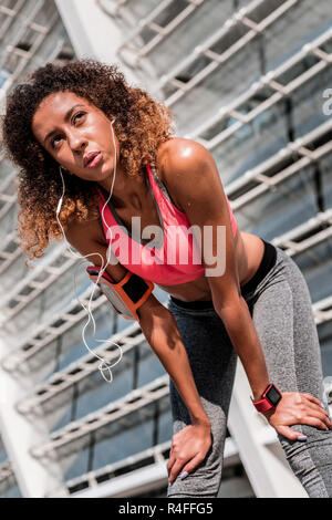 Nice pleasant young woman touching her knees Stock Photo