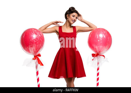 Girl in red dress with huge lollipops Stock Photo