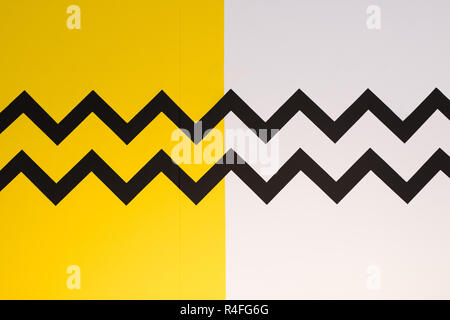 Zigzag painted wall surface with yellow, white and black paint Stock Photo