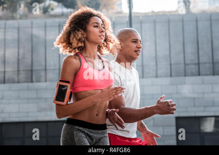 Nice young couple taking part in the marathon Stock Photo