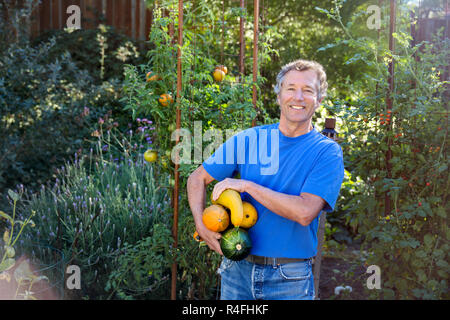 Mature man Farmer Posing with Vegetables Stock Photo