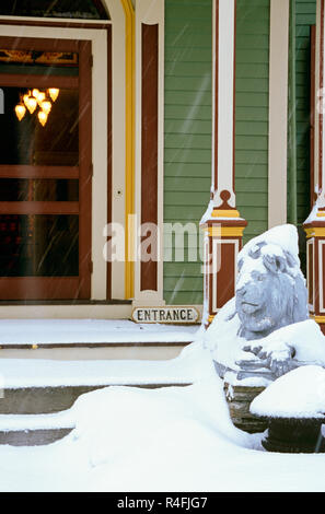 Front Door and Porch of the Landmark Inn in a Snowstorm, Cooperstown, NY, USA Stock Photo