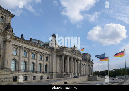 Reichstag building, (german government) with flags in Berlin the capital city of Germany, Europe, blue sky with copy space Stock Photo