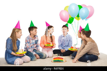 happy children in party hats with birthday cake Stock Photo