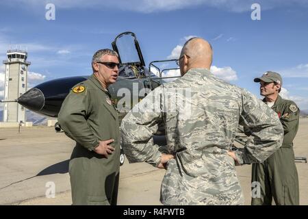 Lt. Col. Ron King, left, and Jim Harkins, both pilots from the 82nd Aerial Targets Squadron, Detachment 1, Holloman Air Force Base, New Mexico, talk with Col. Dana Pelletier, 75th Mission Support Group commander, during a QF-4 Aerial Target aircraft static display at Hill AFB, Oct. 25. Stock Photo