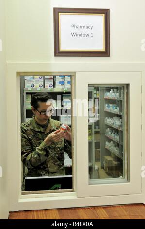 Capt. Sarah Steger, pharmacist with the 31st Combat Support Hospital and Olympia, Wa. native, verifies a prescription Oct. 25, 2016 at Camp Arifjan, Kuwait. Kim along with a small team of Soldiers operate the 31st CSH pharmacy providing pharmaceutical support to patients suffering from injuries and illnesses throughout the ARCENT area of operations. The team processes more than 3,500 outpatient prescriptions a month to service members and civilians while providing support to inpatient care and other facilities throughout the region. Stock Photo