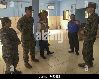 U.S. Marine Capt. Jonathan Martens, an engineering team officer in charge with Special Purpose Marine Air-Ground Task Force - Southern Command, gives a tour of the newly refurbished Puerto Lempira Hospital to Col. Thomas Prentice, left, commander of SPMAGTF-SC, Alberto Haylock, center, governor of Gracias a Dios, and other local leaders in Puerto Lempira, Honduras, Oct. 25, 2016. Renovating the hospital was one of the many engineering projects the Marines and sailors of SPMAGTF-SC conducted while working alongside Honduran engineers during their six month deployment to Central America.  The mi Stock Photo
