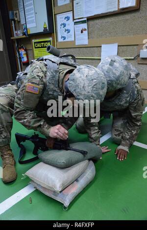 US Navy Sgt. adjusts the sight of his sniper rifle during training ...