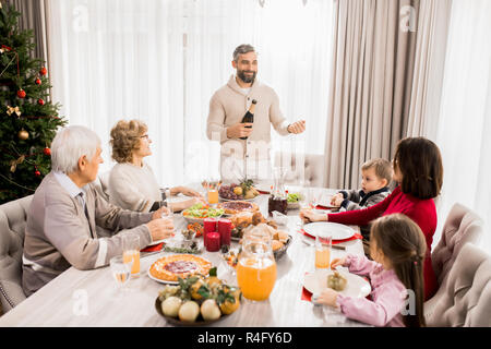 Family Celebrating Christmas at Table Stock Photo