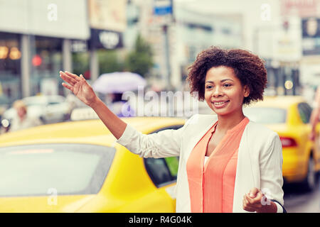 happy african woman catching taxi Stock Photo