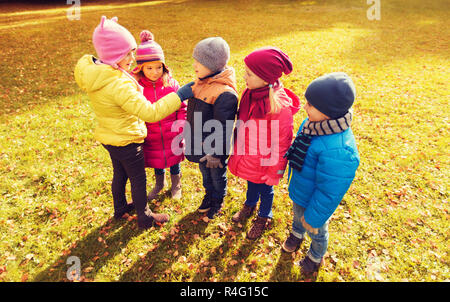 kids in autumn park counting and choosing leader Stock Photo