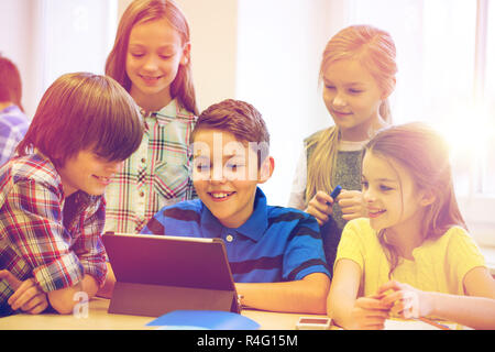 group of school kids with tablet pc in classroom Stock Photo