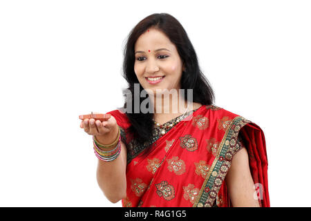 Traditional Indian woman holding the oil lamp Stock Photo