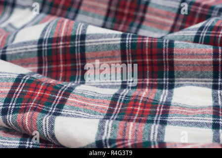 folded creased multicolored checkered woolen fabric background texturr Stock Photo