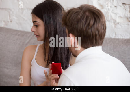 Loving man doing proposal to young woman rejecting offer Stock Photo