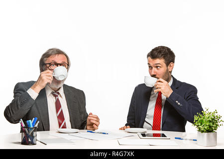 The two colleagues working together at office on white background. Stock Photo