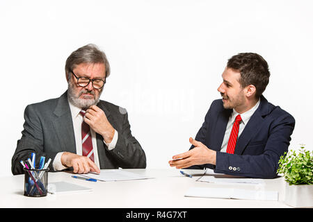 The two colleagues working together at office on white background. Stock Photo
