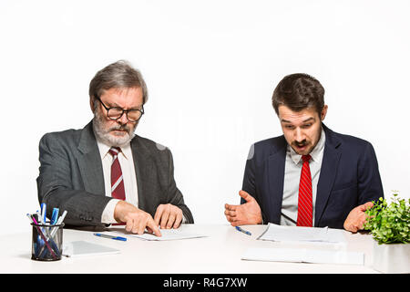 The two colleagues working together at office on white background. Stock Photo