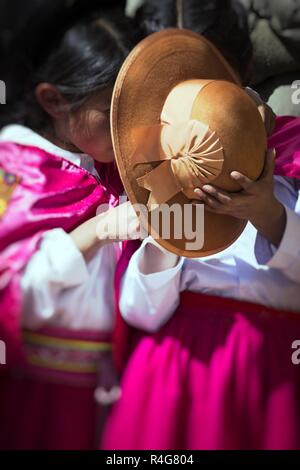 Puno, Peru - August 20, 2016: Native people from peruvian city dressed in colorful clothing perform traditional dance in a religious celebration. Peru, South America. Stock Photo