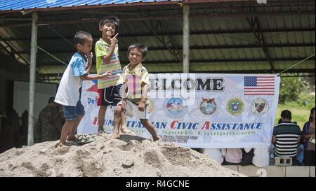 Filipino children pose for a photo at a disaster preparedness symposium during Balikatan 2017 in Ormoc City, Leyte, May 2, 2017. The Armed Forces of the Philippines along with representatives from Japan Self-Defense Force, Australian Defence Force, and U.S. military worked with a local barangay to improve health conditions and disaster preparedness. Balikatan is an annual U.S.-Philippine bilateral military exercise focused on a variety of missions, including humanitarian assistance and disaster relief, counterterrorism, and other combined military operations. Stock Photo