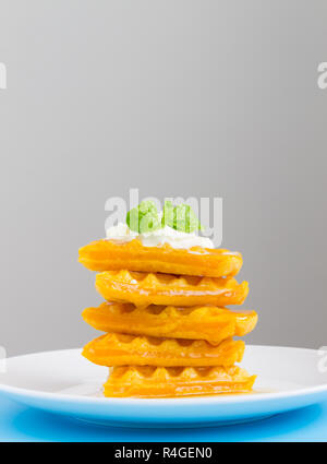 5 Pieces Heart Shape Waffle and Peppermint on Grey Background Portrait. Heart shape waffle dessert for food and dessert category Stock Photo