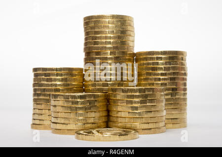 Six stacks of coins increasing in height on a white background Stock Photo