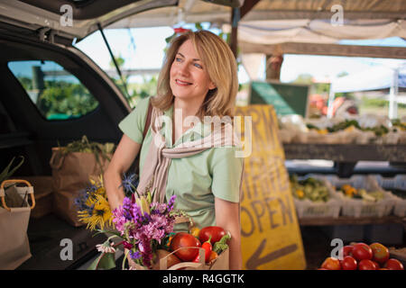 Portrait of a middle-aged woman shopping at a farmer's market. Stock Photo