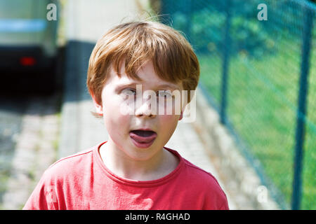 boy shows his tongue Stock Photo