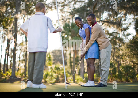 Family playing golf Stock Photo