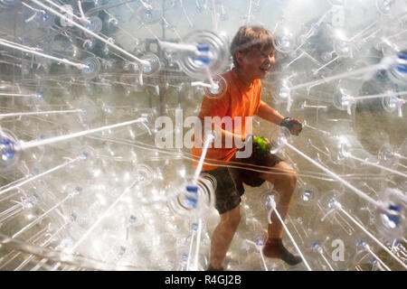 child has a lot of fun in the Zorbing Ball Stock Photo