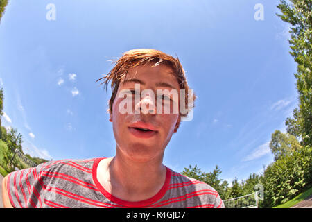 young happy boy sweating and exhausted from sports Stock Photo