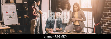casual businesspeople working together using computer in loft office with backlit Stock Photo
